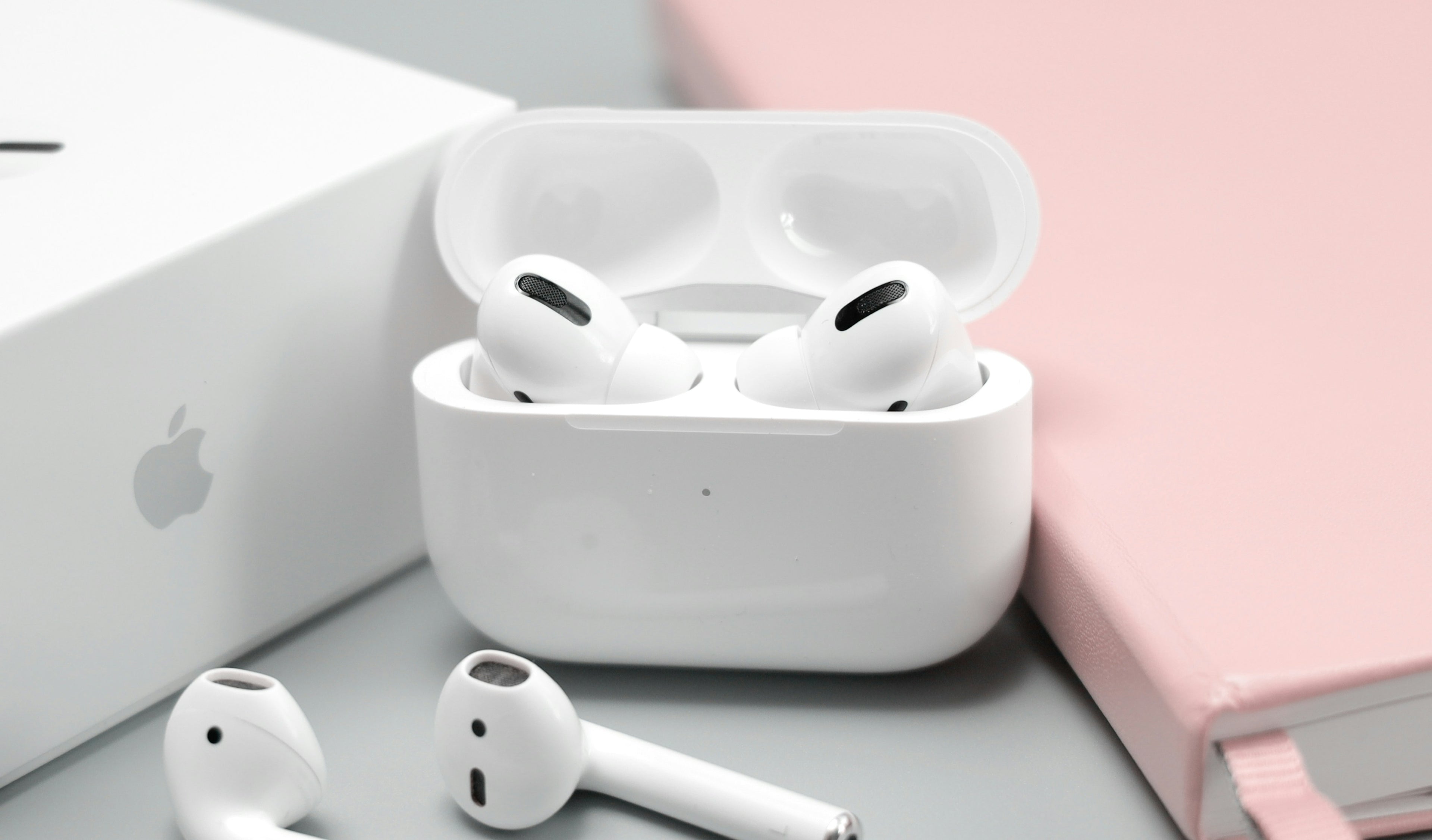 Wireless earbuds in charging case on desk